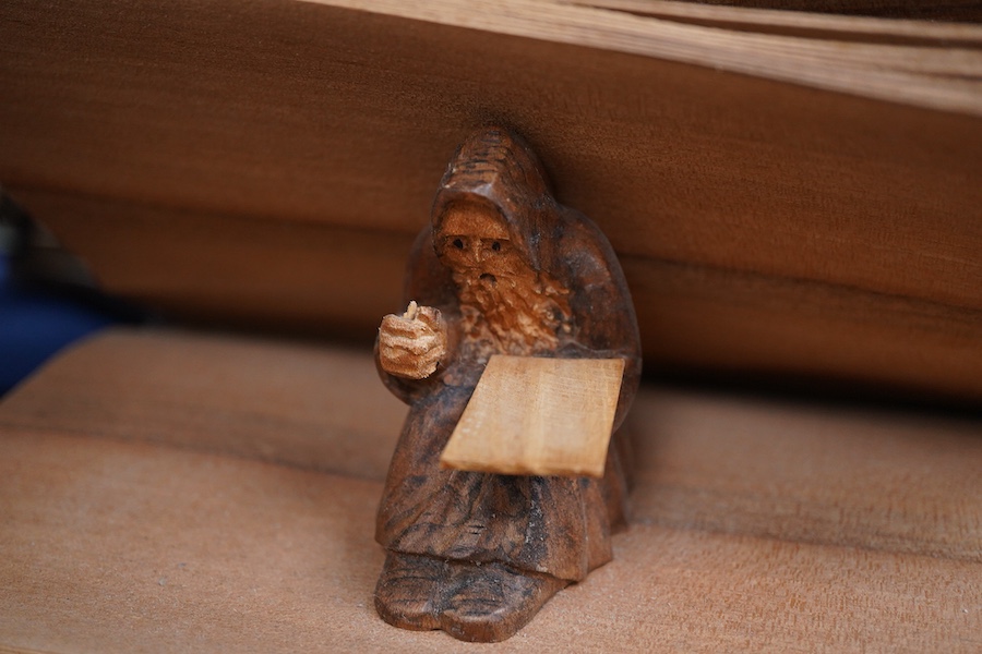 Pierre Decorse (b.1953), two carved wooden sculptures, an egg with a miniature town emanating from its top; and a stylised burger, largest 14cm wide